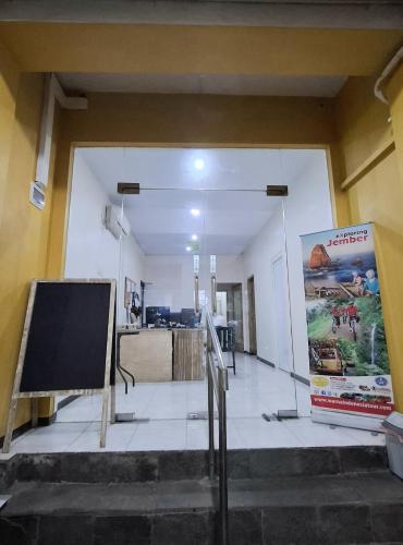 a building with a sign in the middle of a hallway at Huis TANTI Homestay Jember in Wirolegi