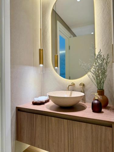 a bathroom with a bowl sink and a mirror at Architect Designed house 2 BR with Private Pool in Dubai