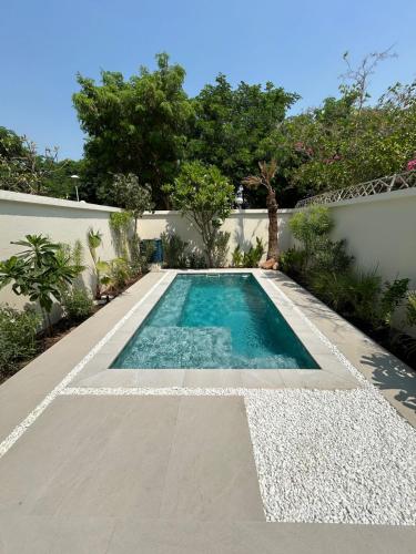 a swimming pool in the backyard of a house at Architect Designed house 2 BR with Private Pool in Dubai