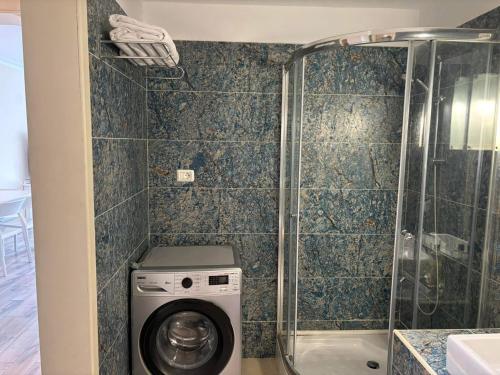 a bathroom with a washing machine and a shower at Domina Coral Bay Resort Elisir in Sharm El Sheikh