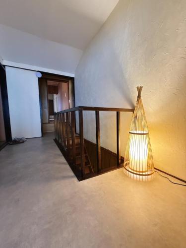 a lamp sitting in the middle of a room at つむぎの宿いちTsumugi's inn Ichi in Joetsu