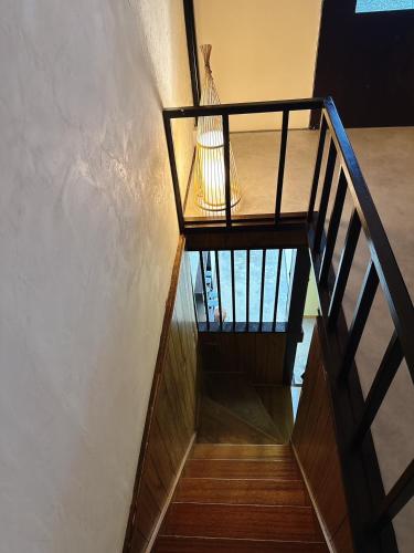 a wooden staircase with a metal railing in a building at つむぎの宿いちTsumugi's inn Ichi in Joetsu