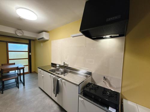 a kitchen with a sink and a stove at つむぎの宿いちTsumugi's inn Ichi in Joetsu