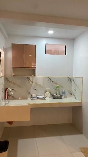 a kitchen with a marble counter top and a sink at Isla Haus Boracay in Boracay