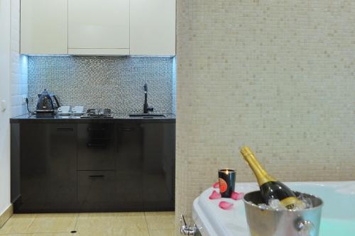 a kitchen with a sink and a bottle of wine at Luxury apartment in Old Town in Klaipėda