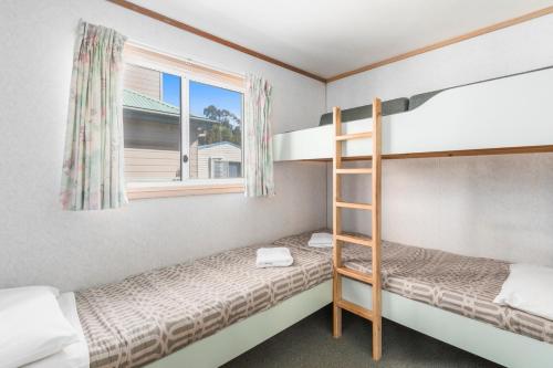 a bedroom with two bunk beds and a window at Ingenia Holidays Eden Beachfront in Eden