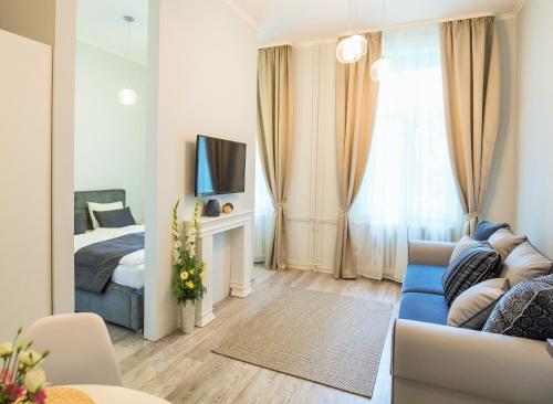 a living room with a bed and a couch at Eden Center Home in Győr