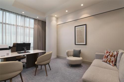 an office with a couch and a desk with a computer at Hyatt Centric Santo Domingo in Santo Domingo