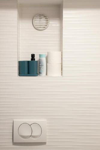 a bathroom with a shelf with towels and a sink at Private Secluded Studio in Sesvete