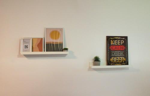 a picture of a microwave and a sign on a wall at Private Secluded Studio in Sesvete