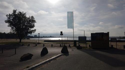 a park with rocks in the middle of a street at Chalet Meerwijck mit Terrasse am Wasser und Meer mit Schwimmbad in Kropswolde