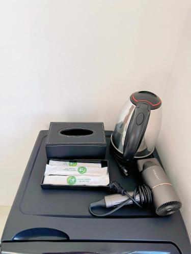 a black table with a lamp and other items on it at Ania Beachside Hotel Da Nang in Da Nang