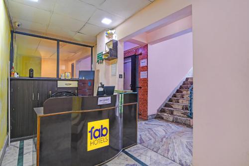 an office with a reception desk and stairs at FabHotel Relyef Inn in kolkata