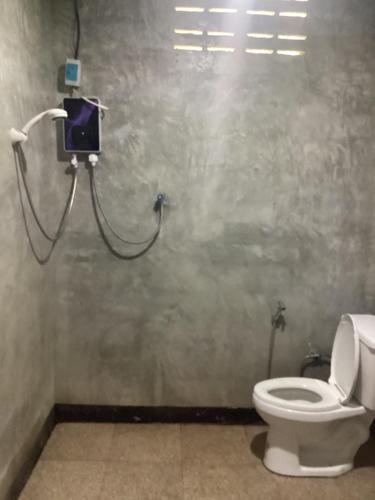 a bathroom with a toilet and a camera on the wall at Baan Saitharn Koh Lanta in Ban Not (1)