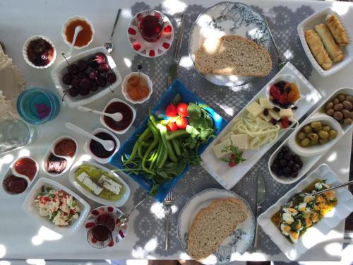 a table with a bunch of different types of food at Cunda Adali Pansiyon in Ayvalık