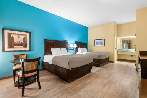a hotel room with two beds and a desk at Quality Inn Union City US 51 in Union City