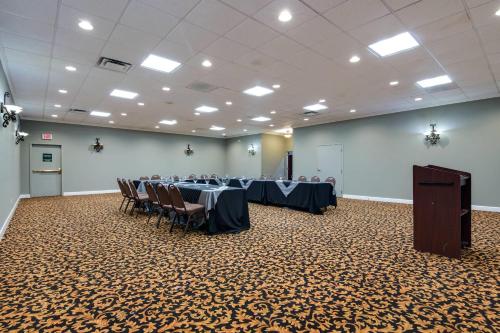 a conference room with tables and chairs and a podium at Quality Inn Oneonta Cooperstown Area in Oneonta
