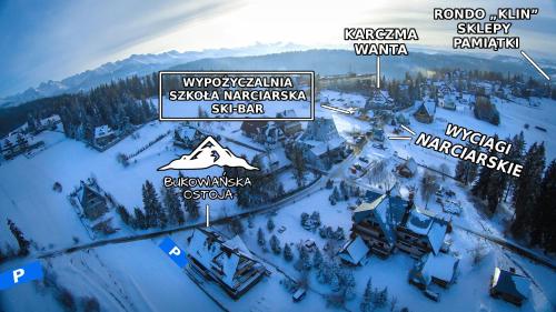 ein Schild für ein Skigebiet im Schnee in der Unterkunft Bukowiańska Ostoja - 60m od Wyciągów- Sauna Balia i Jacuzzi w Ofercie in Bukowina Tatrzańska