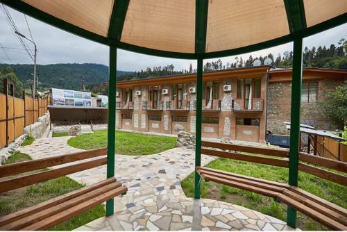 a group of benches in front of a building at Hotel Old Borjomi in Borjomi