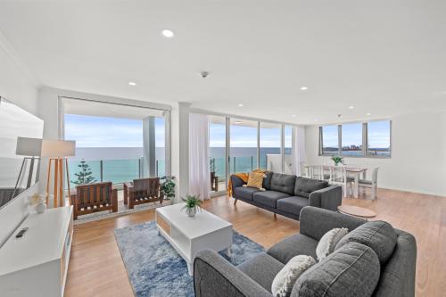 a living room with a view of the ocean at Northwind Beachfront Apartments in Mooloolaba