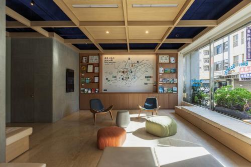 a large room with chairs and a large window at Hotel Ever Spring - Penghu in Magong