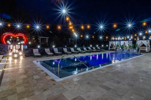 a pool at night with stars on the ceiling at PENSIUNEA MIHAELA-Transalpina in Novaci