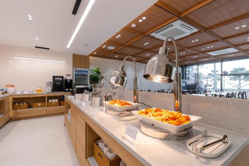 a kitchen with two bowls of food on a counter at Pohang Yeongildae Beach Hotel in Pohang