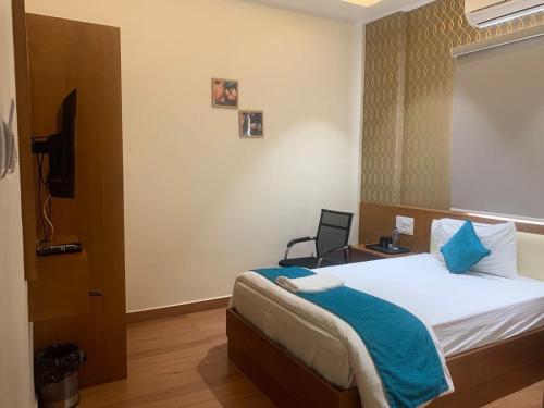 Postel nebo postele na pokoji v ubytování Collection O Pavithra Sangamam Ghat Vijayawada
