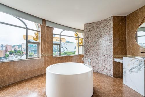 広州市にある广州维福顿白宫酒店のバスルーム(白いバスタブ、窓付)