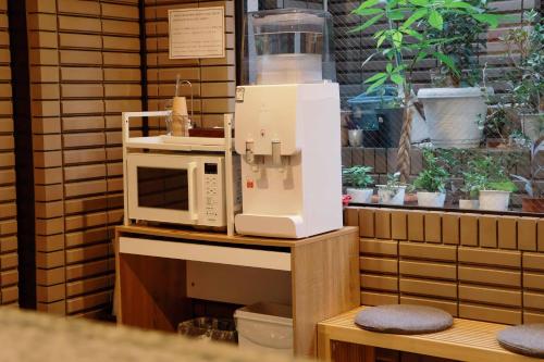a microwave sitting on top of a counter at Hananoie華之家 in Tokyo