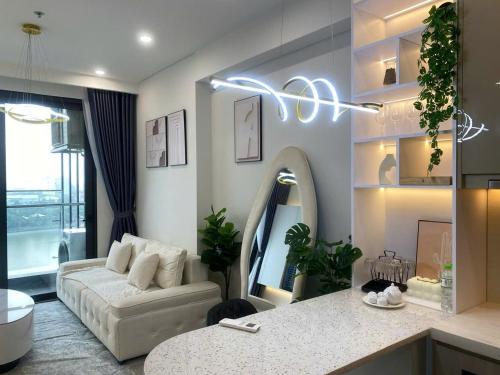 a living room with a couch and a table at Vinhomes Smart City Tây Mỗ Dani Apartment in Hanoi