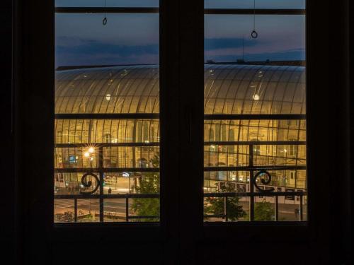 a view of a building through two windows at Ibis Budget Strasbourg Centre Gare in Strasbourg