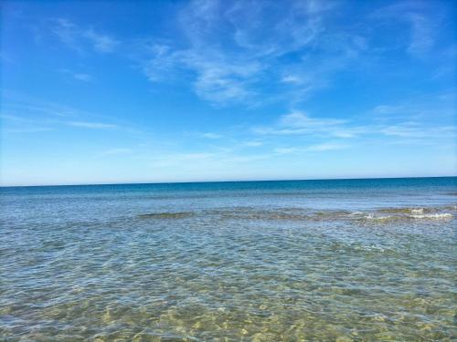 a large body of water with a blue sky at Casa Vacanze Mare Gargano Puglia Marina Di Lesina - 4g min in Lesina