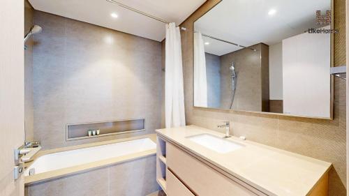 a bathroom with a sink and a mirror at Stay Steps from Burj Khalifa & Dubai Mall With Skyline Views 2BR Downtown Like Home in Dubai