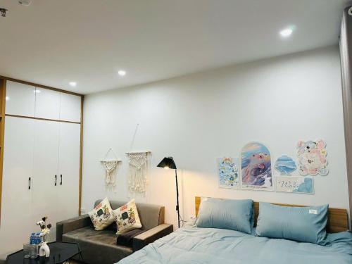 a bedroom with a large bed and a couch at Phố Homestay Hà Nội in Hanoi