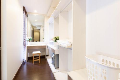 a bathroom with white walls and a sink and a tub at Laguna Park Phuket in Bang Tao Beach