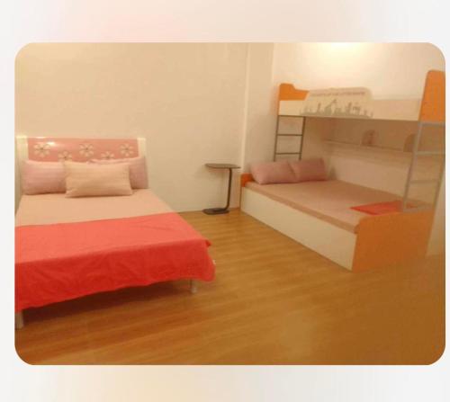 a room with two beds and a bunk bed at Clarin's Beach in Sampong