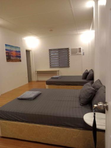 a room with two beds in a room at Clarin's Beach in Sampong