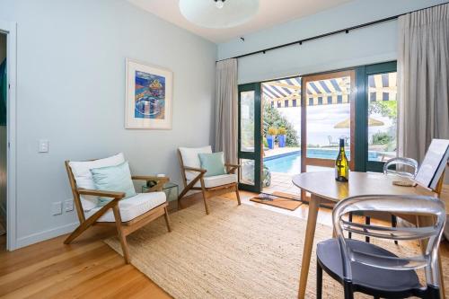 a living room with a table and chairs at House of Pania BnB, clifftop retreat with soul in Napier