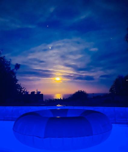 a view of a sunset with the sun in the sky at House of Pania BnB, clifftop retreat with soul in Napier