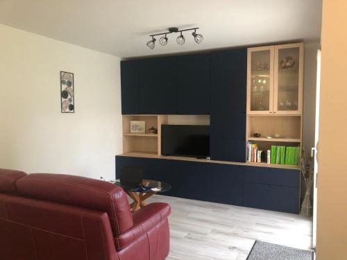 a living room with a couch and a television at Maison d'hôtes Saïx in Saix