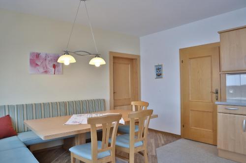 a kitchen with a dining room table and chairs at Oberauhof in Kleinarl