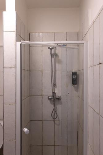 a shower with a glass door in a bathroom at Hotel Sport Houštka 