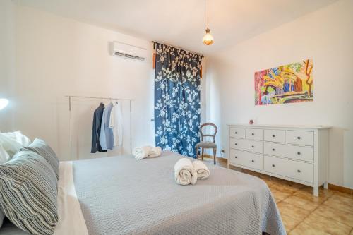 a bedroom with a bed with towels on it at Villa Linda con Terrazzo in Giardini Naxos
