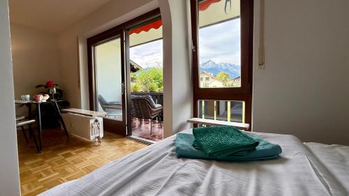 a bedroom with a bed and a large window at Studio Bergblick 5 in Garmisch-Partenkirchen