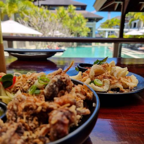 a table with two plates of food on it at Luxury Romance - 5 to Beach in Casuarina