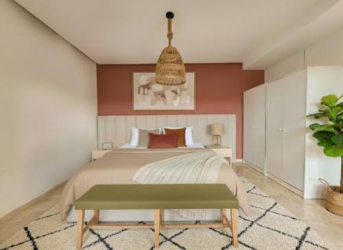a bedroom with a bed and a potted plant at Luxueux appartement de plage Surf & Golf Néroli 13 in Tamraght Ouzdar