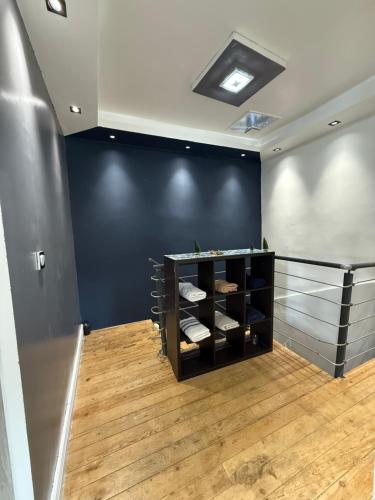 a room with a black wall and a shelf with towels at Spa relaxing in Maisdon-sur-Sèvre