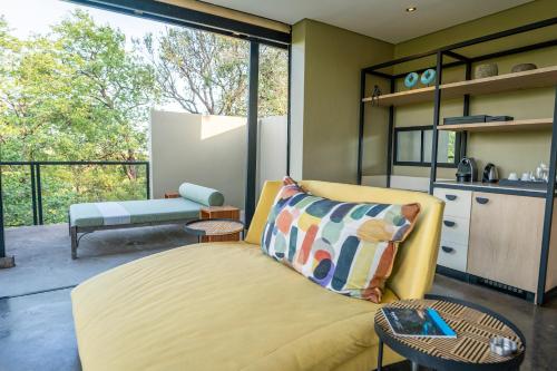 a living room with a yellow couch and a table at The Outpost in Makuleke Contract Park