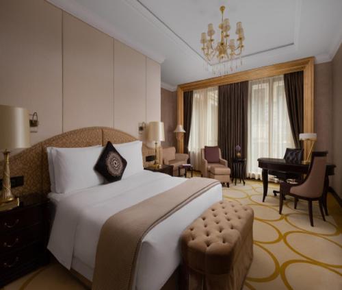 a hotel room with a large bed and a piano at Hotel OPAL PLAZA Near Delhi Airport Unit BY GROSS GROUP in New Delhi